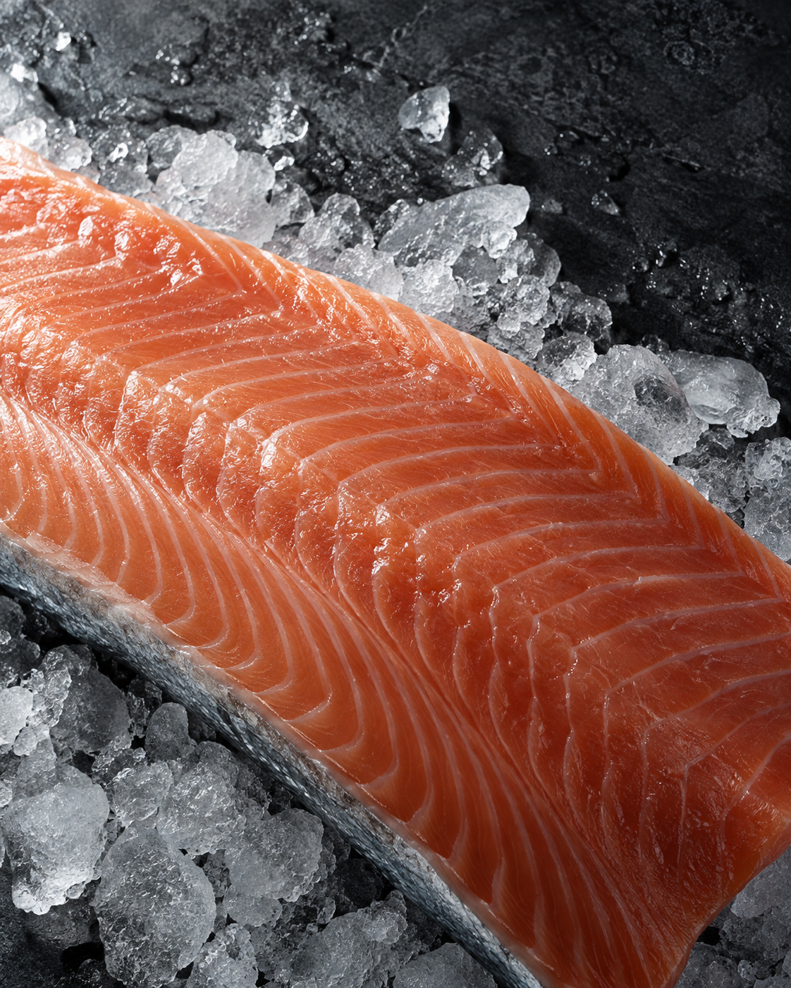 Close-up of salmon flesh and silver skin on crushed ice